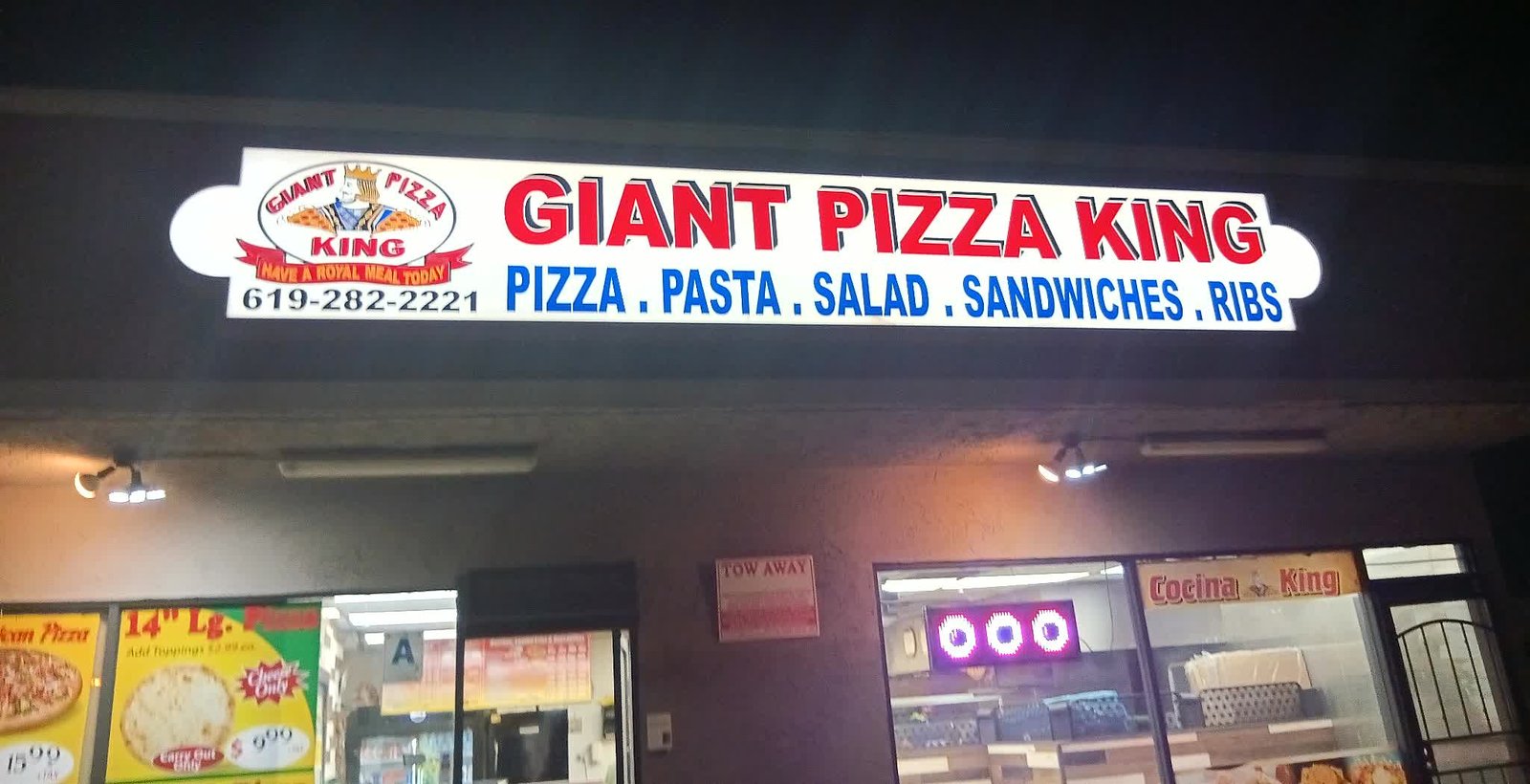 Giant Pizza King storefront sign at night — Pizza, Pasta, Salad, Sandwiches, Ribs