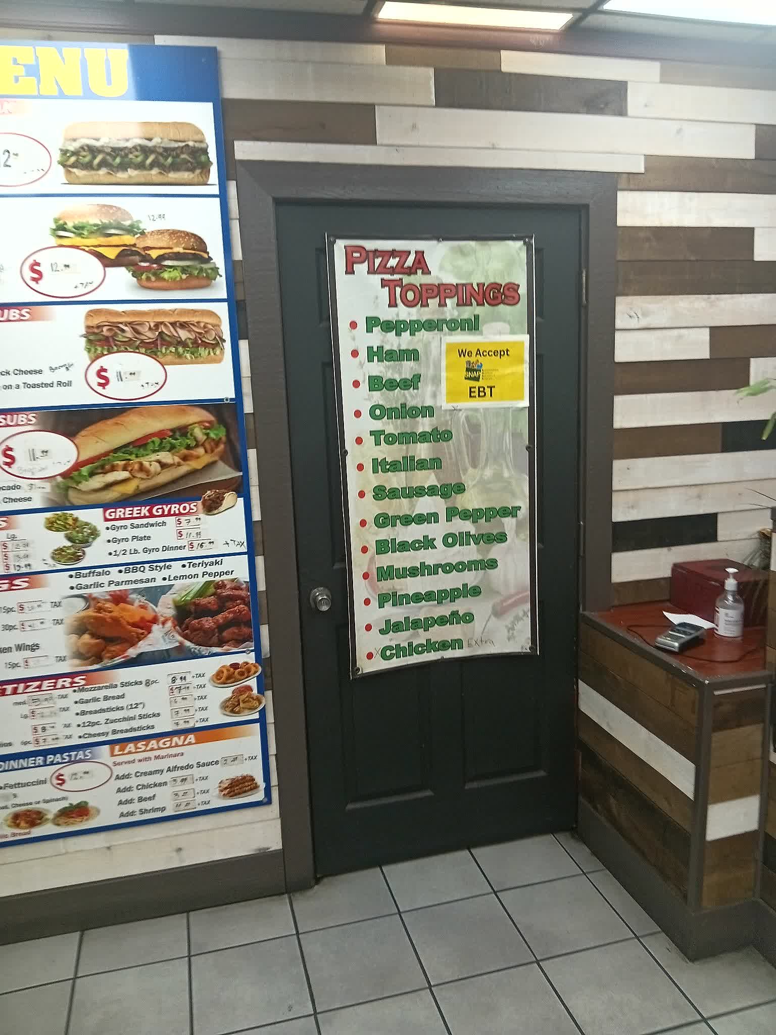 Pizza toppings list and EBT sign on the door